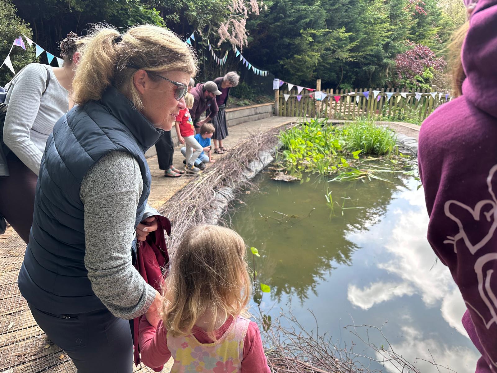 children around a pond