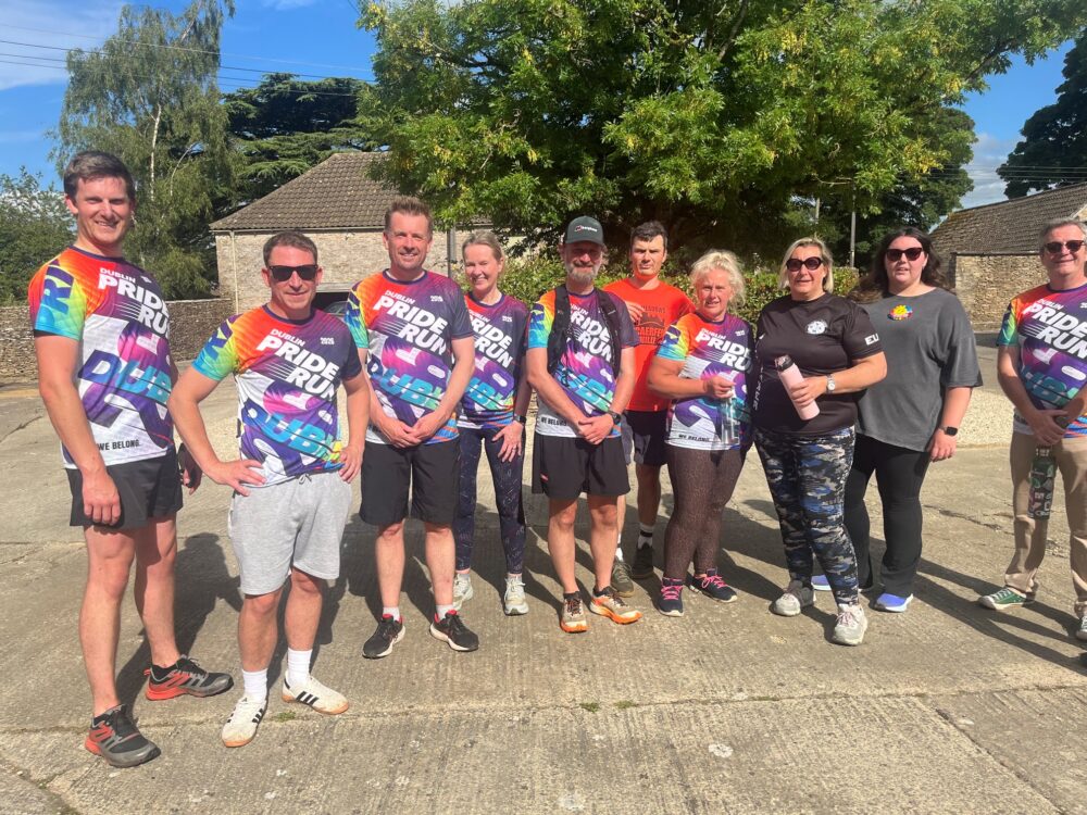 Group of runners standing for a photo wearing sports gear